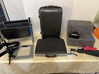 Full lot overview showing suitcase, attache, magazine rack, scale, hair dryer, pet stairs, dock clock, umbrellas