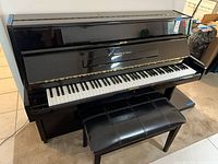 Frontal view of Schafer & Sons upright piano with bench