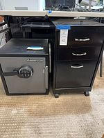Front view of safe and cabinet side by side under desk