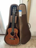 Taylor GS Mini guitar in open padded gig bag