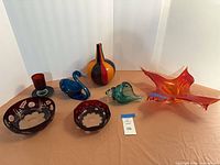 All seven art glass pieces arranged on tabletop