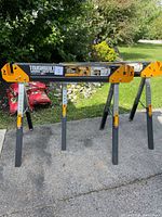 Two ToughBuilt C600 sawhorses unfolded on driveway