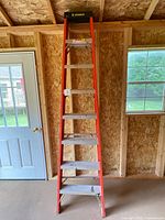 Full view of 8 ft Featherlite step ladder standing in workshop