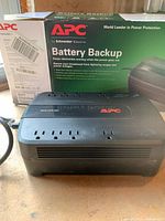 APC Back-UPS 550 unit in front of original box