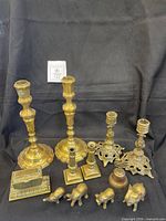 Full lot showing candlesticks, elephants, bell, matchbox