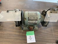 Full view of Delta bench grinder showing both wheels and eye shields