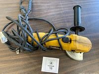 Full view of DeWalt angle grinder with cord and side handle