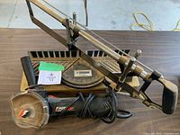 Top view of Mastercraft miter saw and RotoZip saw on table