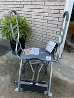 Front view of assembled Pilates Pro Chair with DVDs and manual on seat