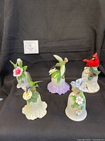 Group shot of all five porcelain bird bells