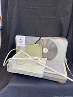 Overall view of Rival meat slicer showing blade, carriage and power cord