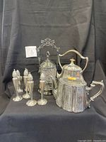 Group shot of shakers, teapot, castor set