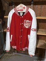 Front view of red/white varsity jacket on hanger