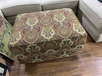 Front and side view of rectangular paisley upholstered ottoman