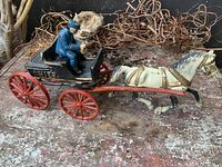 Full view of cast iron fire chief wagon with horse, driver, red wheels