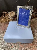 Front view of Seagull pewter picture frame with floral motif and Masterwork box
