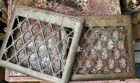 Both rectangular cast iron grate covers showing diamond lattice with leaf detailing