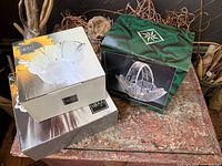 Three boxed crystal pieces on table