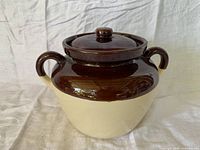 Front view of two-tone stoneware bean pot with lid