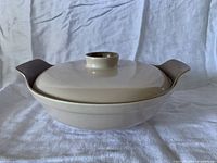 Side view of Poole Pottery covered serving dish showing lid, knob, integrated handles