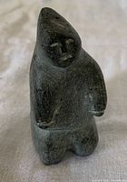 Front view of carved soapstone standing boy figure