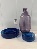 Group shot showing purple vase and three blue bowls