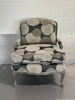 Front view of Art Shoppe grey floral bergere armchair