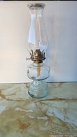 Full view of glass oil lamp with chimney and base