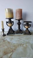 Group shot of all four candle holders with three candles