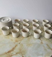Full set of cups and saucers on counter