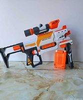 Left side view of assembled Recon MKII with stock, barrel, scope, foregrip and magazine