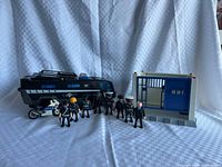 Full set showing command vehicle, motorcycle, eight figures, jail cell