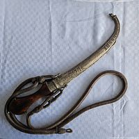 Full view of dagger in sheath with braided cord