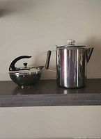 Percolator and tea kettle side by side