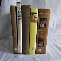Spines of all five hardcover books standing upright