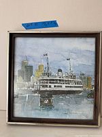 Full view of framed art print with skyline and ferry