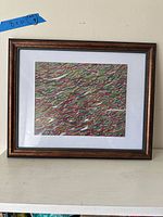 Full view of framed artwork showing mat and frame