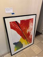 Full framed artwork leaning against wall