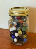 Front view of jar showing assorted marbles