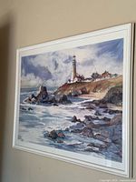 Framed lighthouse coastal print on wall