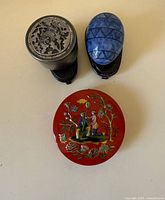 Overview of three trinket boxes and stands