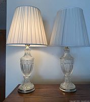 Both crystal lamps with shades on furniture