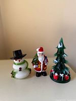 Front view of snowman, Santa and tree figurines