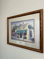 Angled view showing full framed painting on wall