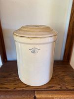 Front view of ivory glazed crock with crown 6 mark