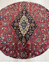 Full view of round Persian Kashan rug