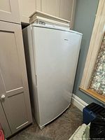 Front view of Amana upright freezer showing full height and door
