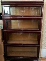 Full front view showing four glass door sections and drawer