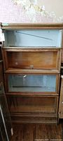 Front view of barrister bookcase showing four sections and drawer