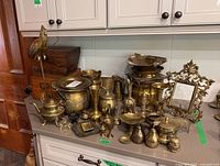 Full view of countertop with brass assortment and wooden boxes